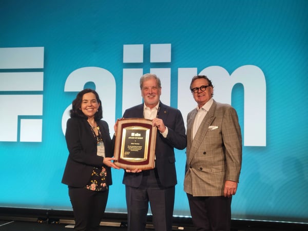 Tori Miller Liu and Craig Laue present John Newton with the Award of Merit